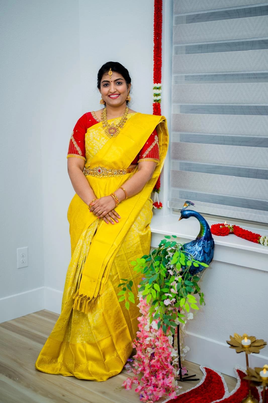 Guru Hema Chandrasekaran in a yellow sari with temple jewelry